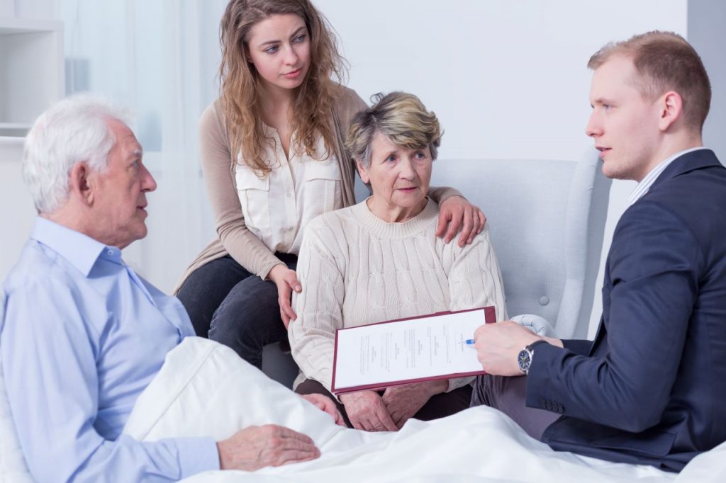 Shot of a family listening to a lawyer discuss a nursing home's forced arbitration document