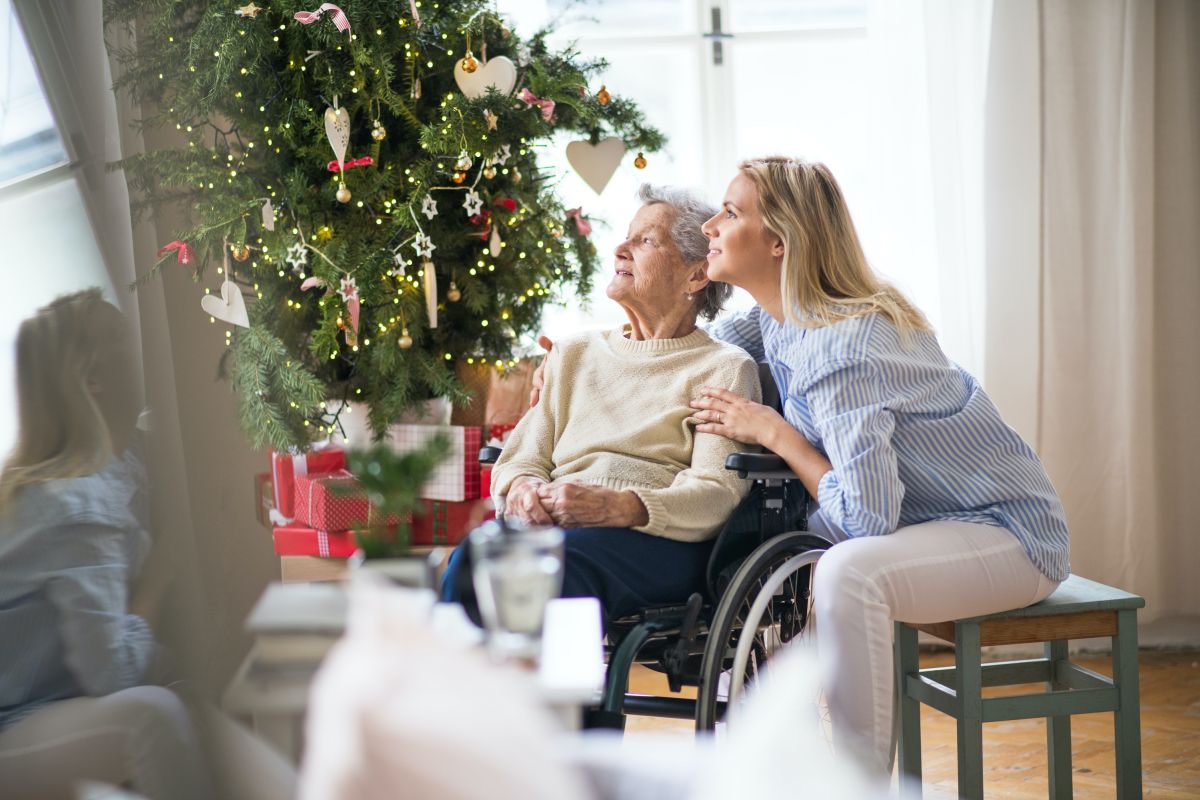 Woman spending time with her mom at a nursing home during the Christmas holiday