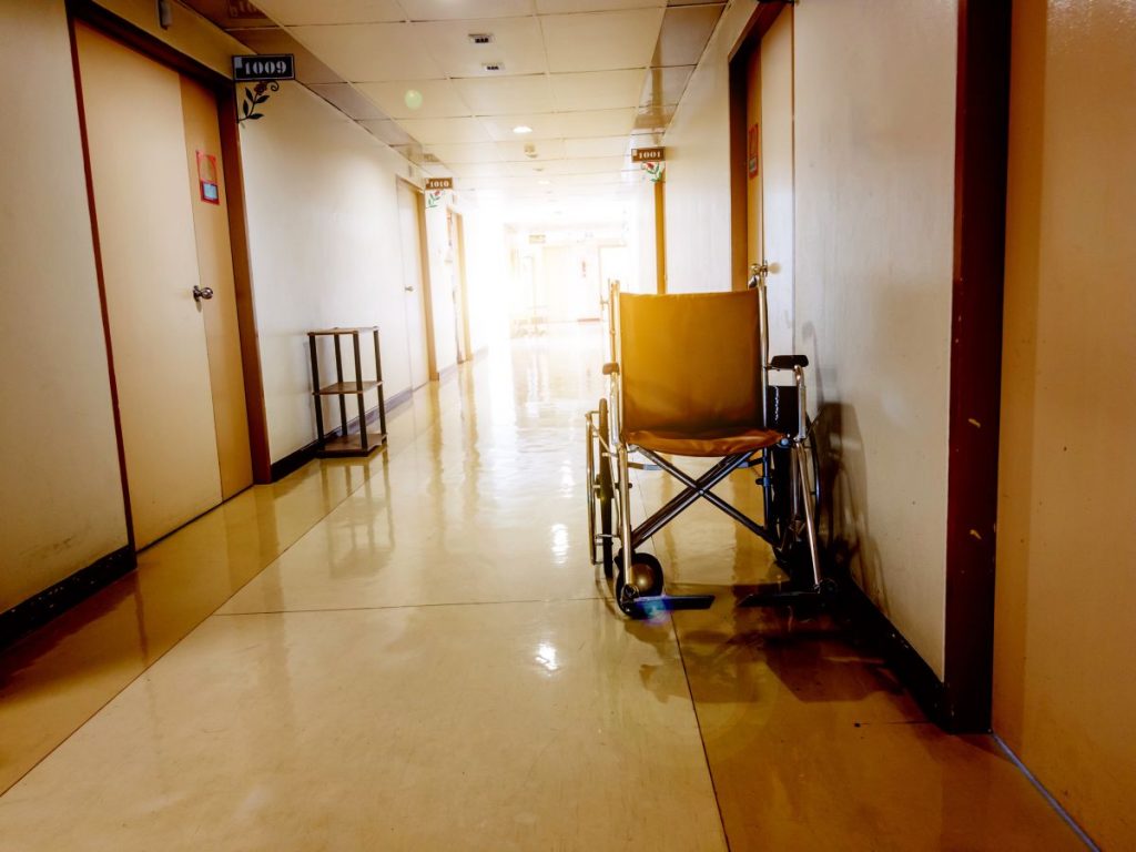 An empty wheelchair in the hallway of a nursing home